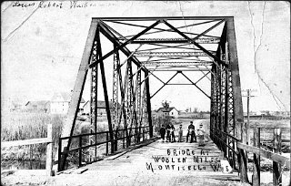 Bridge at Monticello Woolen Mill. Zentner farm and cheese factory, rear left.  One of the boys is Robert Louis Wuilleumier, son of Monticello jeweller, Armand Wuilleumier.